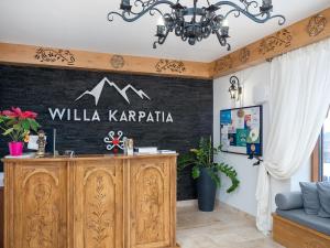 a wall with a sign that reads willka karapaja at ECO Villa Karpatia Ski&SPA in Murzasichle