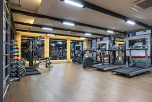 a gym with several tread machines in a room at 1164 Helbor Stay Batel, Conforto e Estilo no Coração de Curitiba in Curitiba