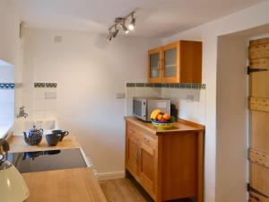 a kitchen with a bowl of fruit on a counter at Seventeen Ten in Castle Carrock