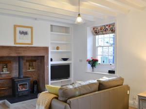 a living room with a couch and a fireplace at Seventeen Ten in Castle Carrock