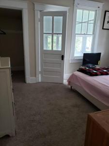 a bedroom with a bed and a window and a door at D.C.'s Brookland house Pets are Welcome! in Washington, D.C.