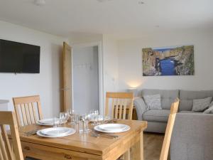 a dining room with a table and a couch at Rockworks Chalets No,2 - Uk7041 in Saint Marys