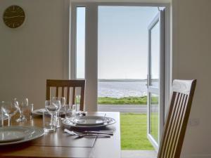 a dining room table with a view of the ocean at Rockworks Chalets No,2 - Uk7041 in Saint Marys
