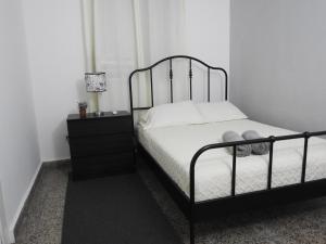 a bedroom with a bed and a dresser with a lamp at Casa Del Sol-Unit A in Bayamon