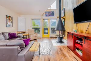 a living room with a couch and a flat screen tv at Mountainside Condo #307 in Girdwood