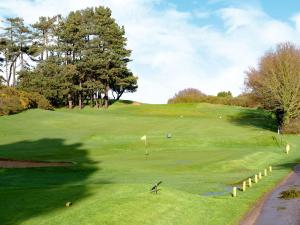 a view of a golf course with a green at Southbank in Mundesley
