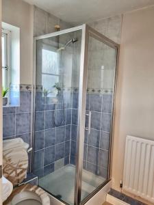 a shower stall in a bathroom with a toilet at Delight Marvel- Beech Hurst-3 bedroom house in Maidstone