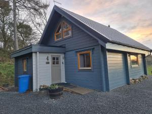 a blue tiny house with a front door at Alban in Linlithgow