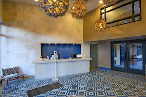 a lobby with a reception desk in a building at La Pinta Hotel in Ensenada