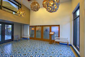 a lobby with two benches and two chandeliers at La Pinta Hotel in Ensenada