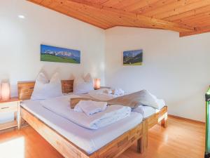 a bedroom with a large bed with white sheets at Itterblick in Itter