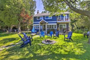 una casa azul con sillas y una hoguera en Charming Cottage on Crystal Lake Fire Pit, Kayaks, en Plymouth