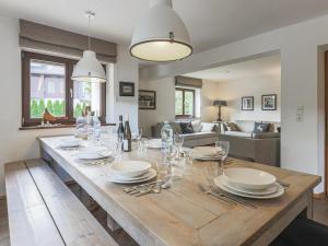 a dining room with a table with plates and wine glasses at Berg und Bach in Kirchberg in Tirol