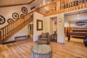 a living room with a staircase and a piano at Aspencliffe Home: Perfect Mountain Getaway w/ Hot Tub in Blue River