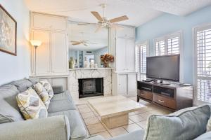 a living room with a tv and a fireplace at Madeira Beach Yacht Club 343 #G in St Pete Beach