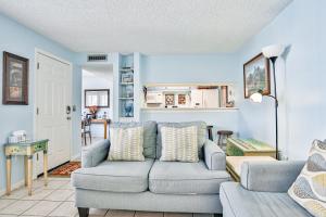 a living room with a couch and a table at Madeira Beach Yacht Club 343 #G in St. Pete Beach