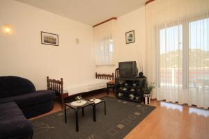 a living room with a couch and a tv at Apartments by the sea Zaklopatica, Lastovo - 8347 in Lastovo