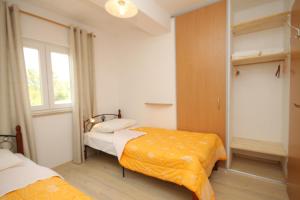 a bedroom with two beds and a window at Apartments with a parking space Trget, Rasa - 7687 in Trget