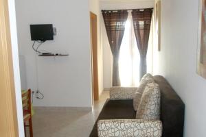 a living room with a couch and a television at Apartments with a parking space Trget, Rasa - 7687 in Trget