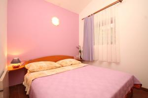 mała sypialnia z łóżkiem i oknem w obiekcie Apartments with a parking space Opatija - 7861 w mieście Opatija