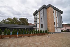 a building with a row of trees in front of it at Villa Mystic in Ohrid