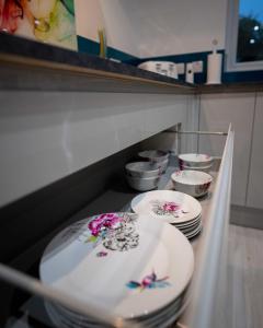 a row of plates on a shelf in a kitchen at Heather House , luxury holiday house in Pitlochry in Pitlochry
