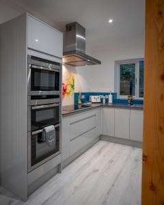 a kitchen with a stainless steel oven and a sink at Heather House , luxury holiday house in Pitlochry in Pitlochry +7 photos