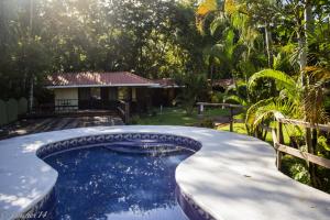 a swimming pool in the backyard of a house at Kalea Yard Hotel in Puerto Jiménez