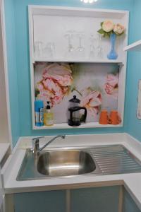 a kitchen sink in a cabinet with a tea kettle at Enchanted Escape in Picton