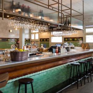 a bar in a restaurant with bar stools at Terminus Hotel Pyrmont in Sydney