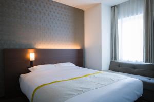 Postel nebo postele na pokoji v ubytování Tosei Hotel Cocone Ueno