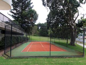 a tennis court with a net on a tennis court at Pinnacle 701 in Forster
