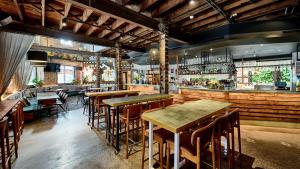 a restaurant with wooden tables and chairs and a bar at The Lucky Hotel in Newcastle