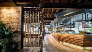 a restaurant with a bar with a brick wall at The Lucky Hotel in Newcastle