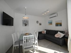 a living room with a couch and a table at House Palma in Selca