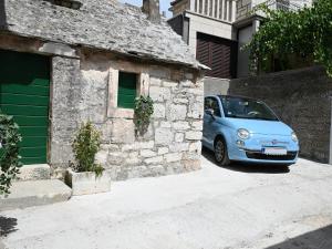 a blue car parked in front of a building at House Palma in Selca +13 photos