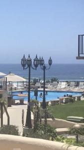 a view of a swimming pool with two lights at Oceana Rosarito Condo Beach frontPrivately Owned downtown best views in Rosarito