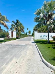 an empty road with palm trees and a building at SeaSide Townhome, Spacious 2br 3bath Leeward Grace Bay, Providenciales, walk to beach in Providenciales