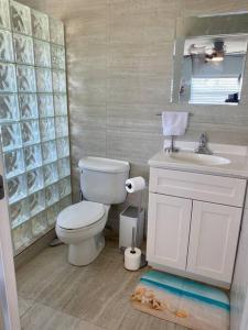 a bathroom with a toilet and a sink at SeaSide Townhome, Spacious 2br 3bath Leeward Grace Bay, Providenciales, walk to beach in Providenciales