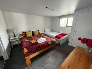 a bedroom with a bed and a couch in it at Scott Street Apartments in Lake Tekapo