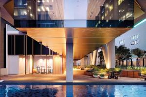 a building with a pool in front of a building at Lovely One Bedroom + Study with Infinity Pool in Sydney