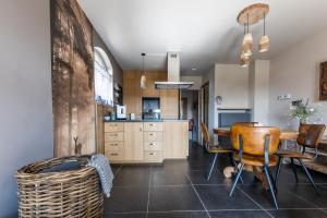 a kitchen and dining room with a table and chairs at vakantiehuis Lavendine Pure in Genk