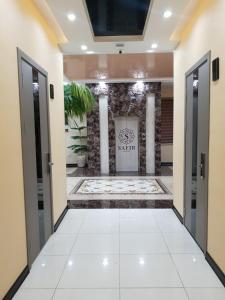 a hallway with doors and a tile floor at SAFIR BUSINESS HOTEL o in Dushanbe
