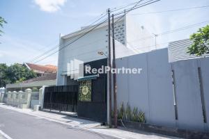 a red perimeter sign on the side of a building at Athena House Syariah Near The Park Mall Solo Baru Mitra RedDoorz in Sukoharjo