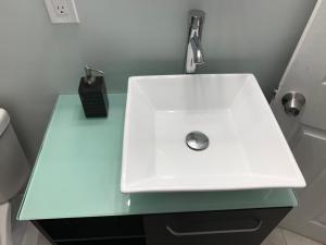 a bathroom with a white sink on a green counter at Private Hollywood APT Near Beach Airport & Casino in Hollywood