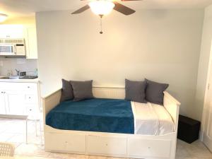 a bedroom with a bed with a ceiling fan at Private Hollywood APT Near Beach Airport & Casino in Hollywood