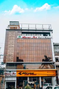 a tall building with a sign on top of it at Hotel Aavas Inn in Tezpur