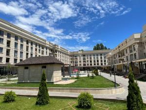 a large building with a park in front of it at Raduga Issyk kul - Радуга Иссык куль in Chon-Sary-Oy +3 photos