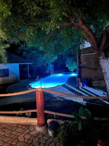 una piscina por la noche con luces azules en Lunar Dive Resort: Bamboo Villas en Kubu