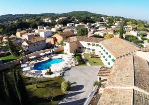 an aerial view of a house with a swimming pool at Logis Hôtel Le Mas De Jossyl in La Roque-dʼAnthéron